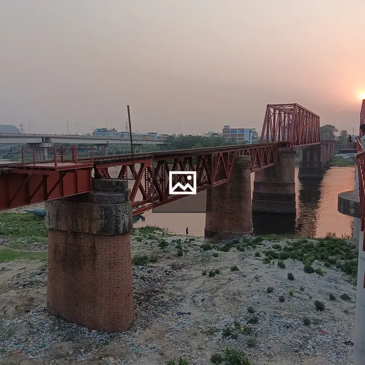 Red railway bridge over river