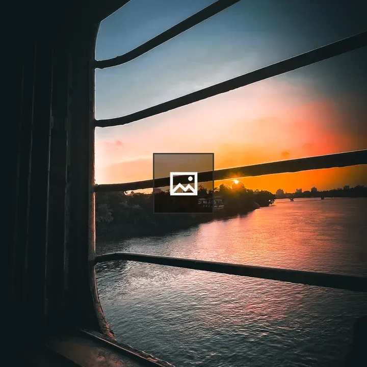 Sunset Over Cityscape from Train Window