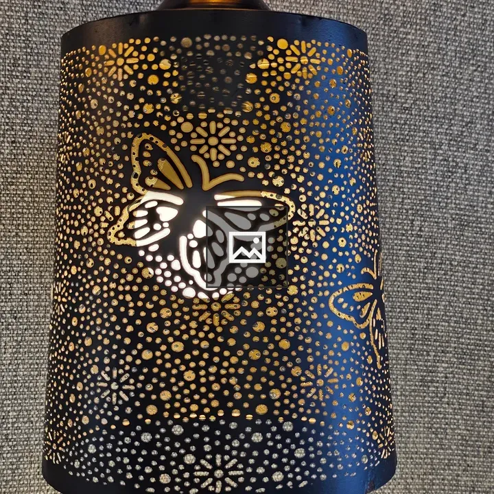 Black metal lantern with butterfly cutouts
