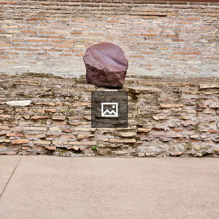 Broken red stone on Roman brick wall