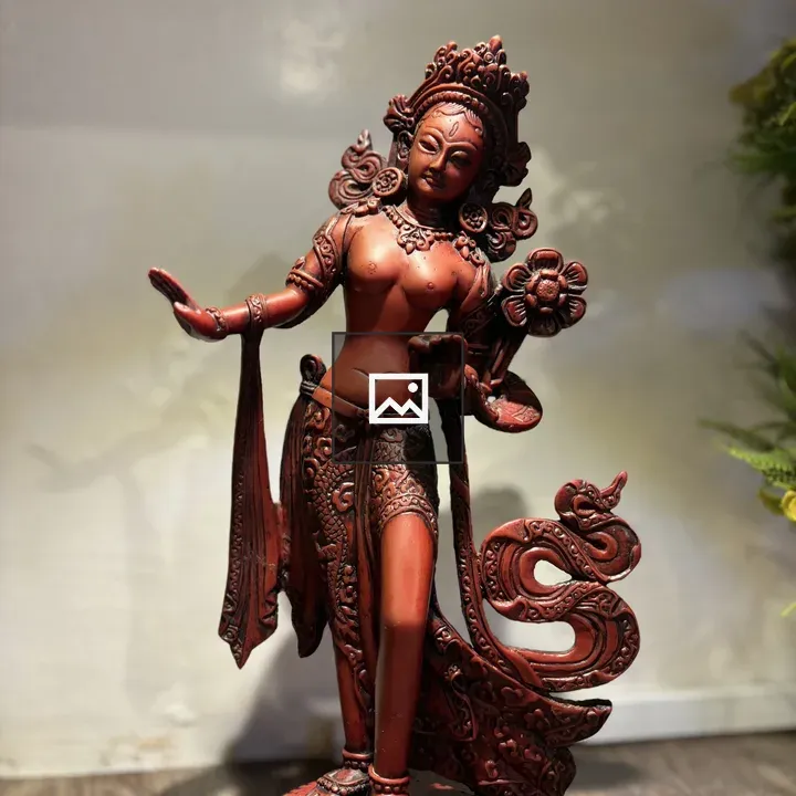 Red statue on flower base