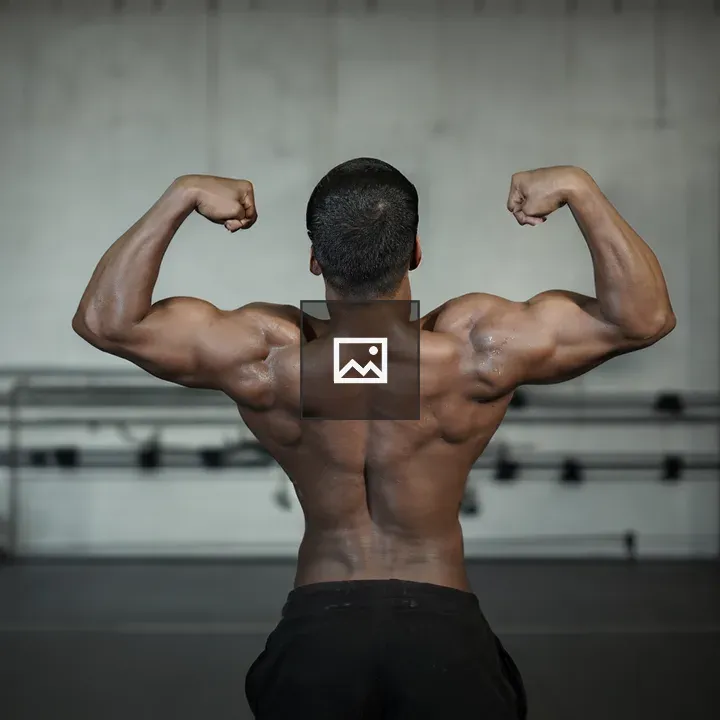 Man seen from behind flexing muscles