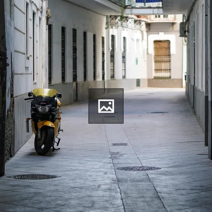 Yellow motorcycle in urban alley