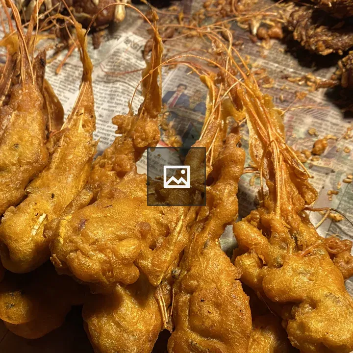 Golden fried prawns on newspaper