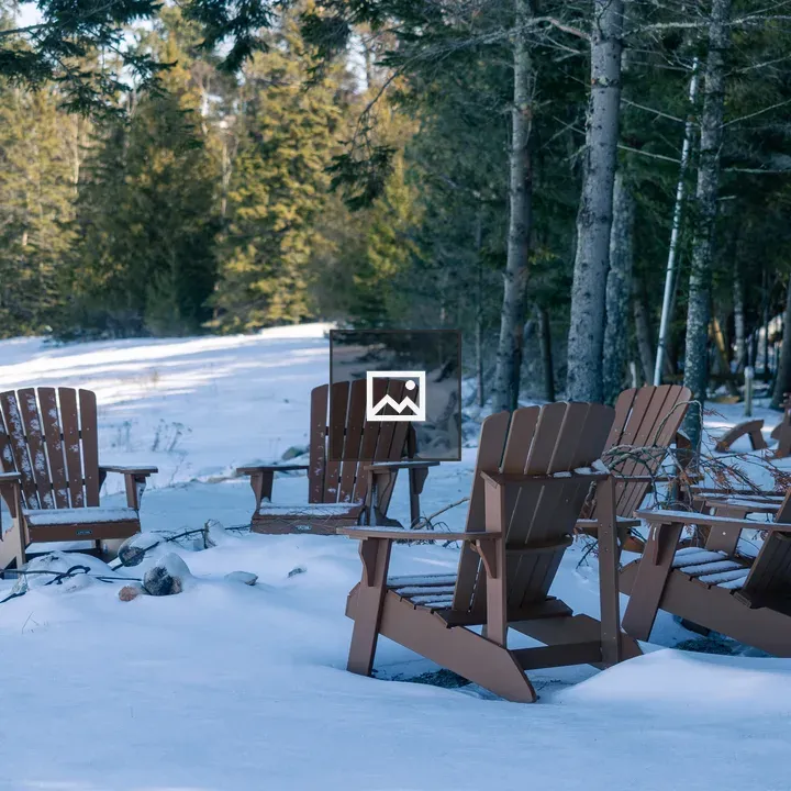 Snow-covered Adirondack Chairs