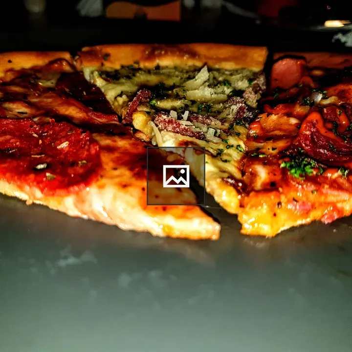 Pizza slices on dark plate