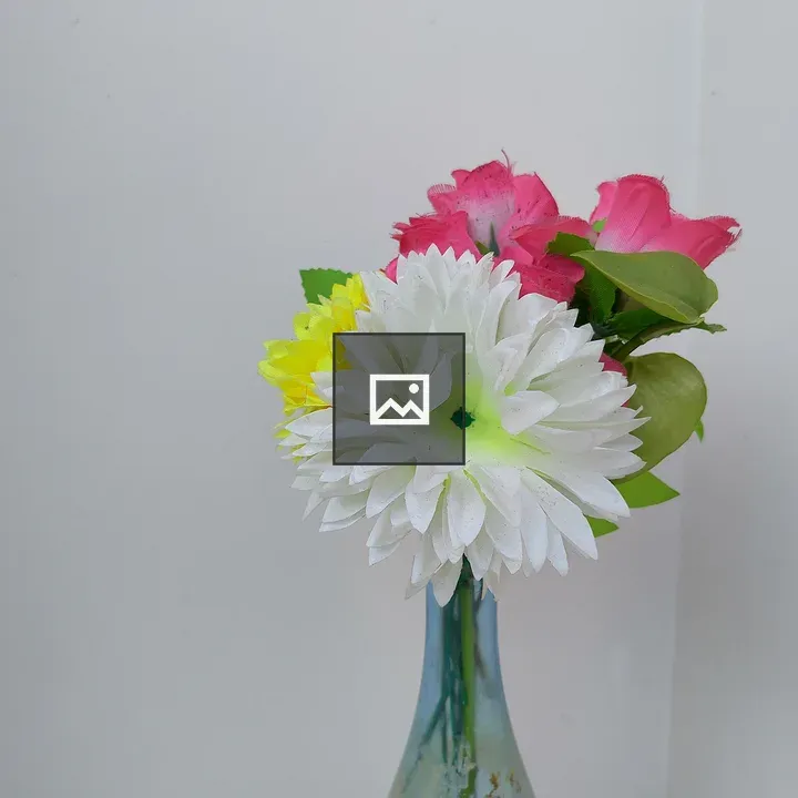 Vase with colorful artificial flowers