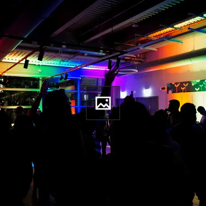 People dancing in colorful lights