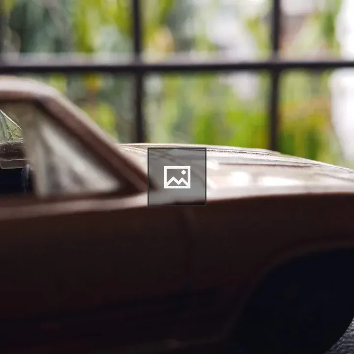 Toy car and vehicles on brown and green