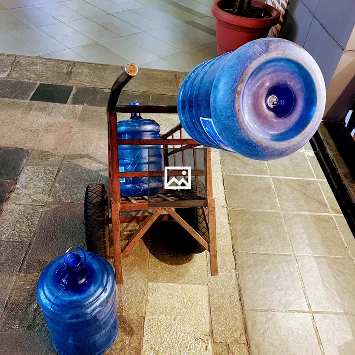 Blue water jugs on hand truck