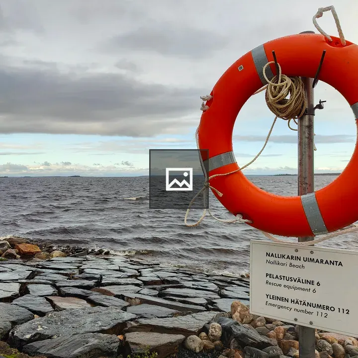Lifebuoy at rocky shoreline