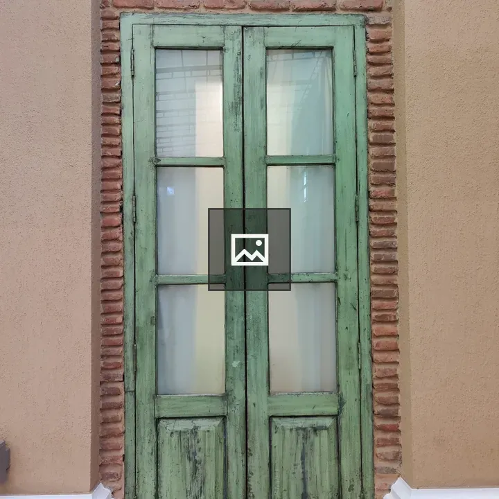 Green double door with glass panels