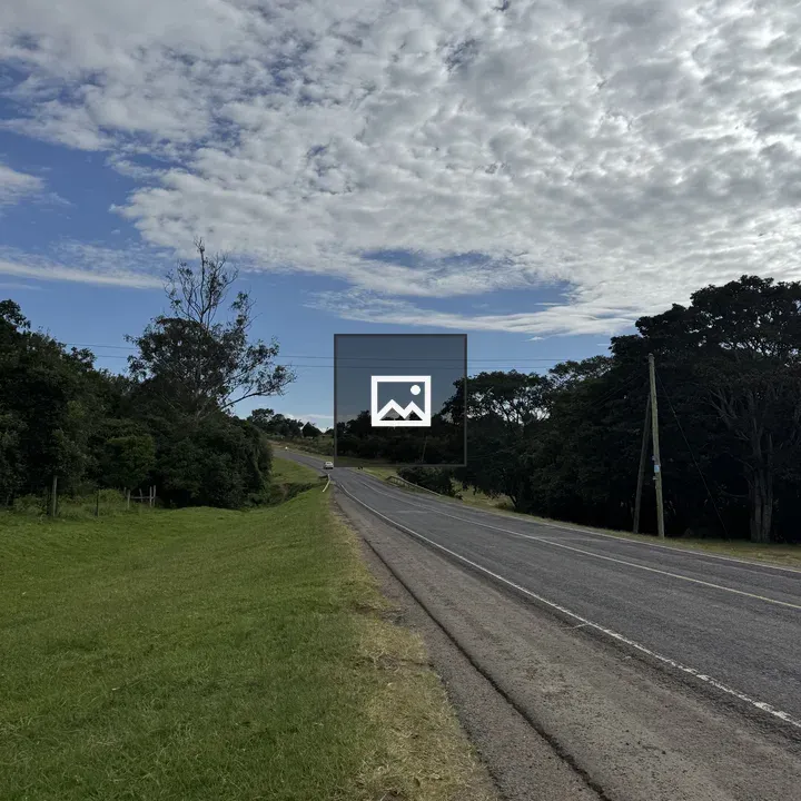 Paved road with grassy shoulder uphill