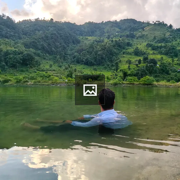 Person sitting in shallow water
