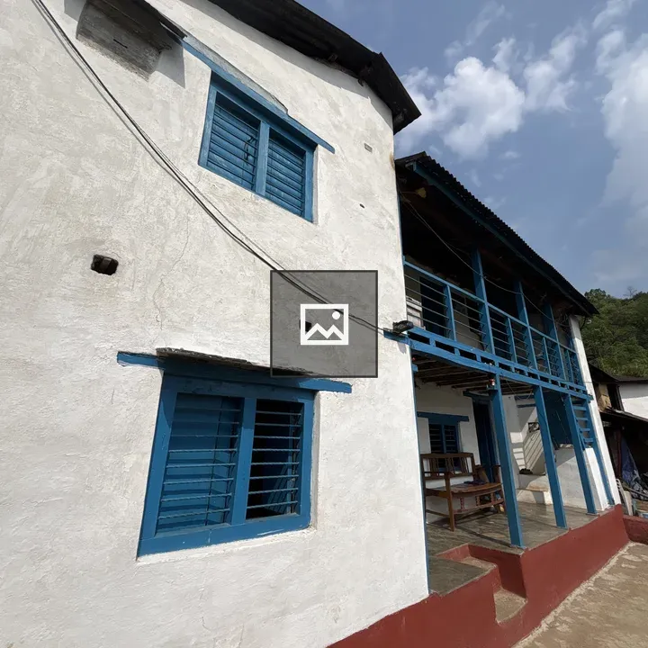 Two-story building with blue window frames