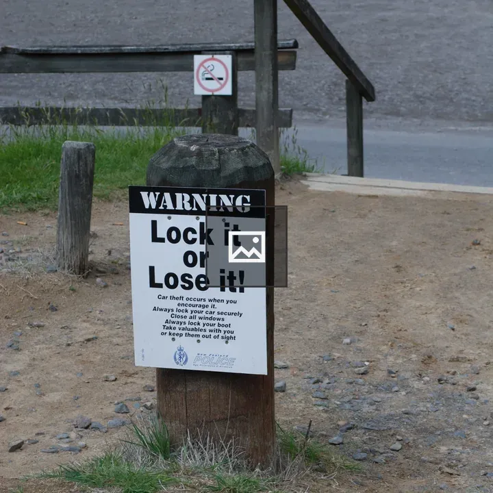 Warning sign on grass patch