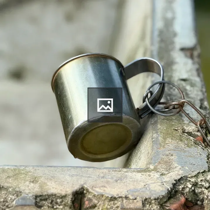 Close-up of metal cup on chain
