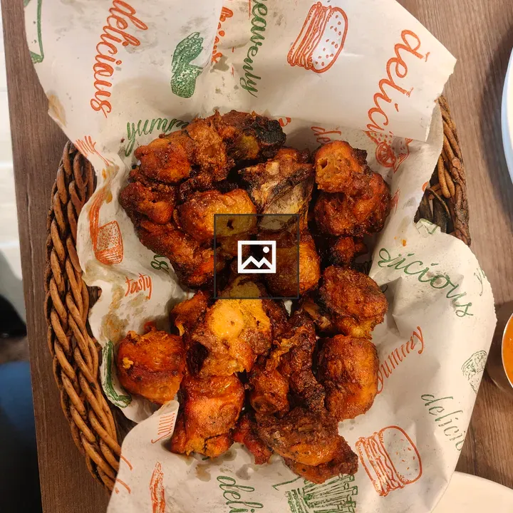 Basket of fried food on wooden table