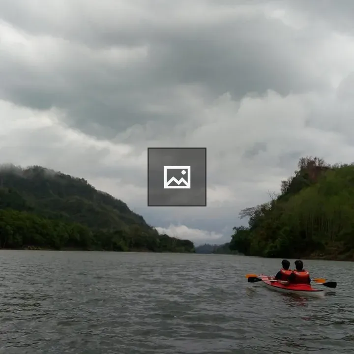 Kayak on a Lake Against Hills