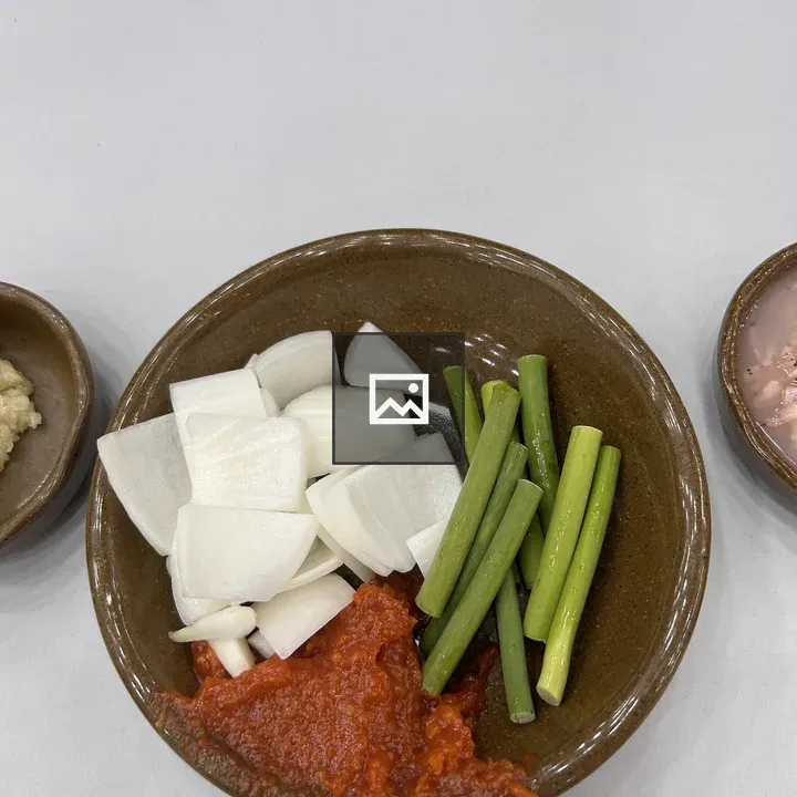 Bowl of chopped onions and chili sauce