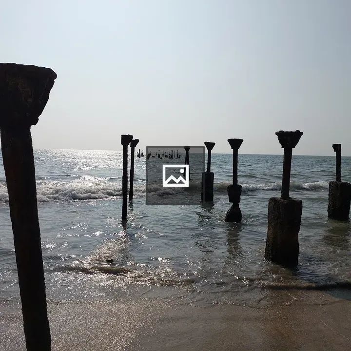 Beach with rusted pillar ruins