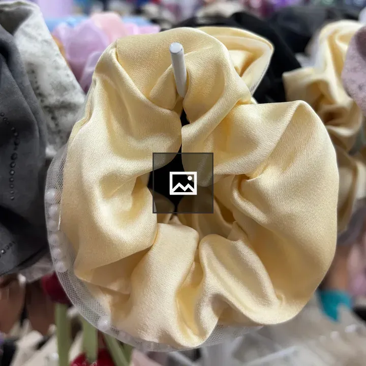 Close-up of yellow satin scrunchie