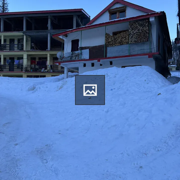 Snowy landscape with two buildings