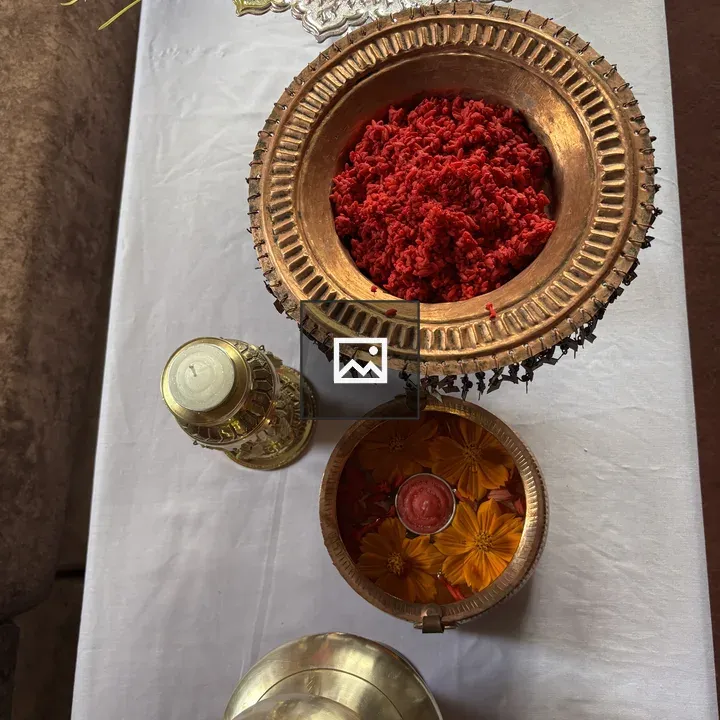 Gold and copper vessels on white cloth