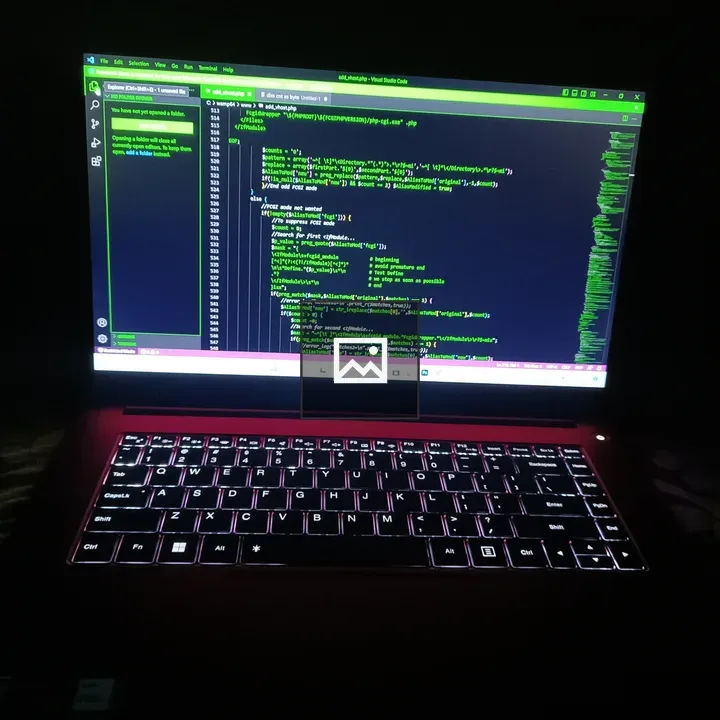 Laptop with illuminated keyboard in dark room
