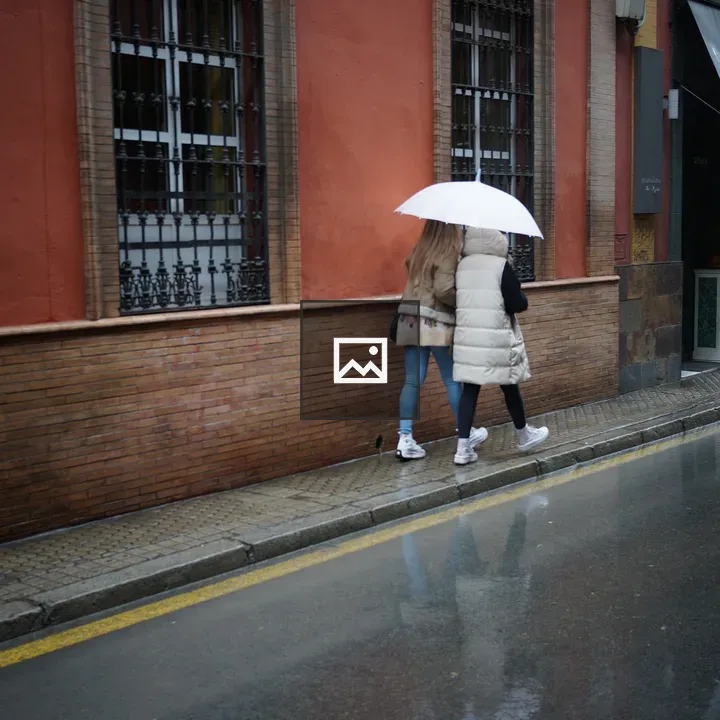 Two women under umbrella in rain