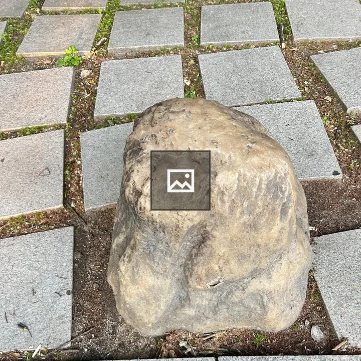 Rock on gray tiled surface