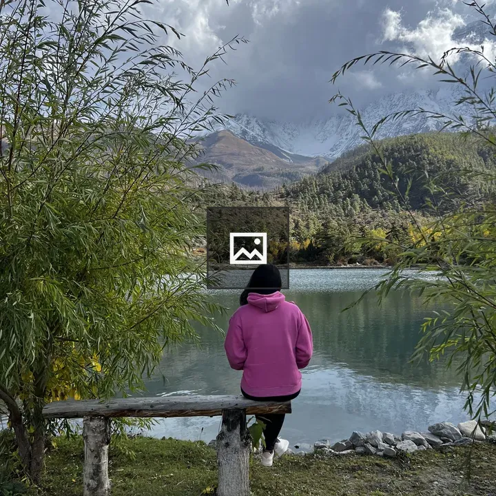 Woman in Pink Hoodie by Lake