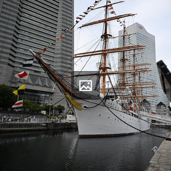 Tall ship with sails near Landmark Tower