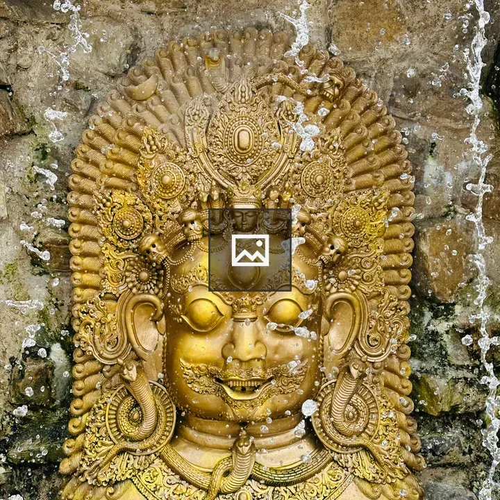 Golden deity face carving