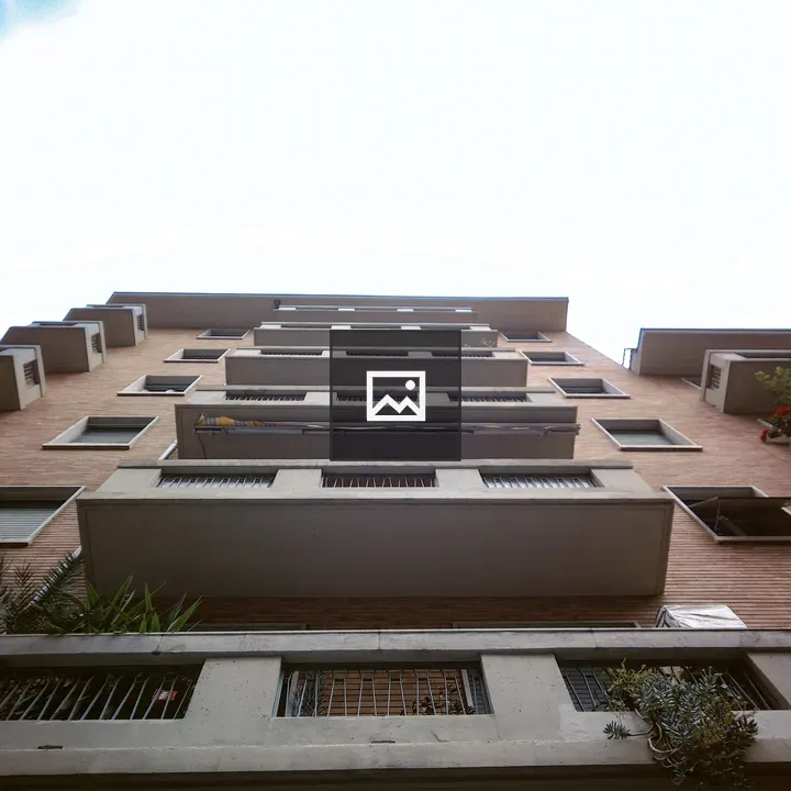 Building with Balconies Under Blue Sky