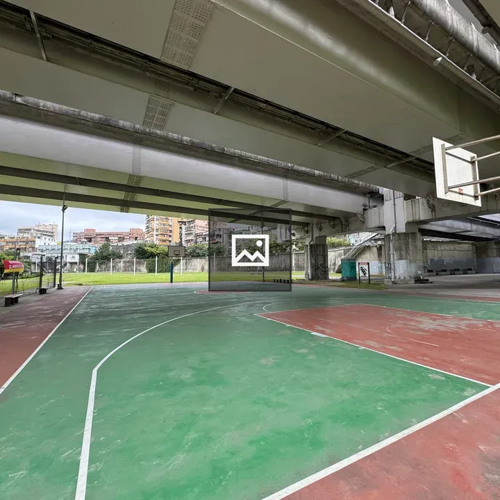 Outdoor basketball court under bridge