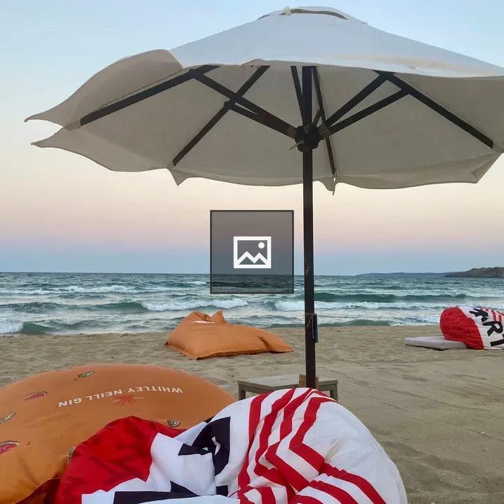 Beach scene with parasol and bean bags