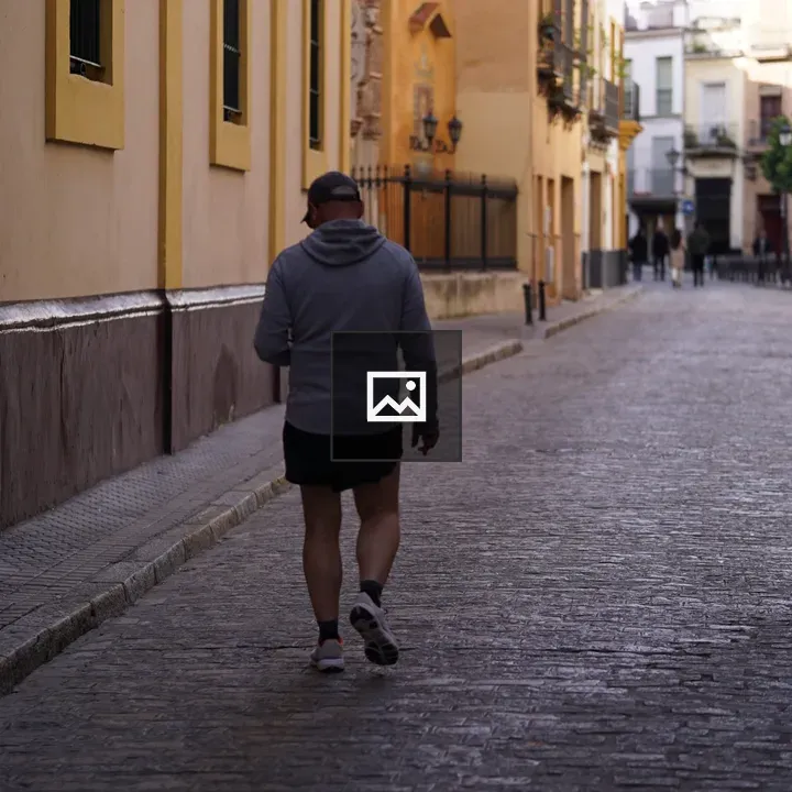 Person walking on colorful cobblestone street