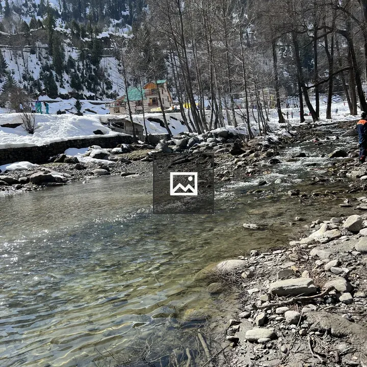 Winter landscape with stream and village