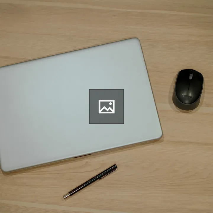 Top view of laptop, mouse, and pen