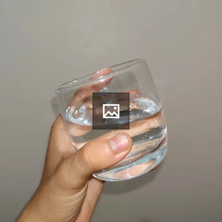 Hand holding glass of water