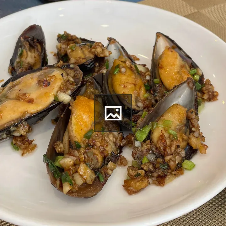Garlic-infused mussels on plate
