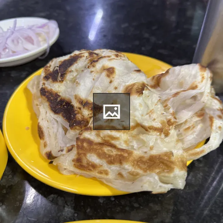Golden brown flatbread on yellow plate