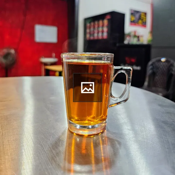Cup of black tea on steel table