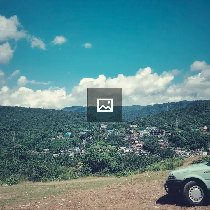 Green car on hilltop overlook