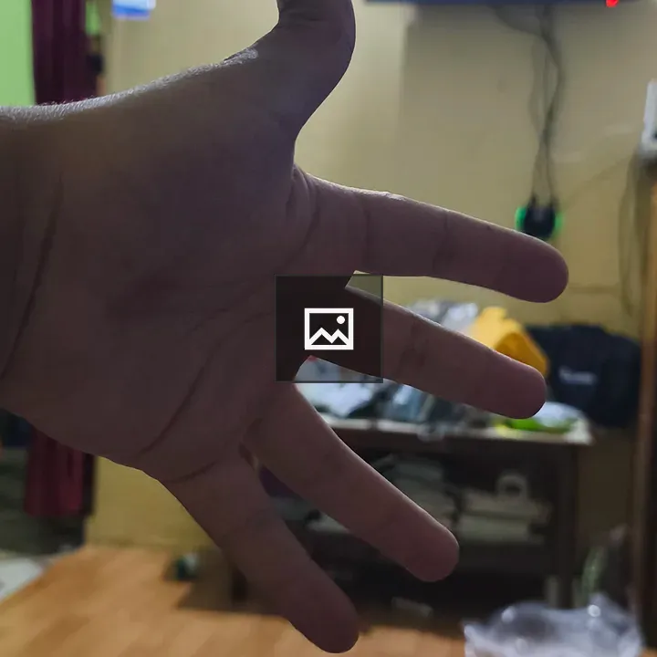 Hand in foreground in living room