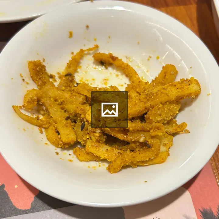 White bowl of crispy pickles