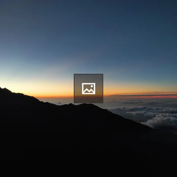 Dark mountain silhouettes at sunrise