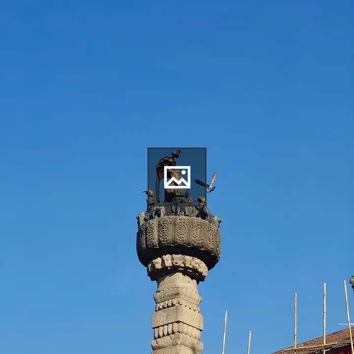 Stone pillar with carved statue