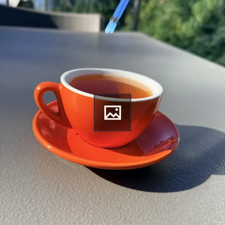 Orange Teacup on Gray Surface